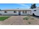 Charming single-story home with a brick walkway and gravel landscaping, complemented by a vibrant blue sky at 15049 N 25Th Pl, Phoenix, AZ 85032