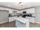 Modern kitchen boasts white cabinets, subway tile backsplash, stainless steel appliances, and a stylish marble island at 15049 N 25Th Pl, Phoenix, AZ 85032