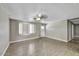 Inviting living room with wood floors, featuring a ceiling fan and a white door for easy access at 15049 N 25Th Pl, Phoenix, AZ 85032