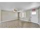 Bright living room with wood flooring, a ceiling fan and a clearly marked exit door at 15049 N 25Th Pl, Phoenix, AZ 85032