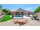 Stunning backyard oasis with a sparkling pool, lush green lawn, and inviting patio area at 17710 W Buena Vista Dr, Surprise, AZ 85374