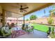 Relaxing covered patio with ample seating, perfect for enjoying the view of the backyard and pool at 17710 W Buena Vista Dr, Surprise, AZ 85374