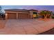 Attractive home exterior with desert landscaping and spacious driveway at 17710 W Buena Vista Dr, Surprise, AZ 85374