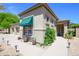 This home's exterior features a two-car garage, desert landscaping and a covered window at 17710 W Buena Vista Dr, Surprise, AZ 85374