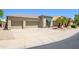 Well-maintained property with a two-car garage, desert landscaping, and a covered window at 17710 W Buena Vista Dr, Surprise, AZ 85374
