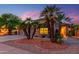 Charming home featuring desert landscaping with palm trees and a well-maintained lawn at 17710 W Buena Vista Dr, Surprise, AZ 85374