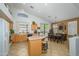 Bright kitchen boasts tile floors, center island with barstool seating, and a dining area with natural light at 17710 W Buena Vista Dr, Surprise, AZ 85374
