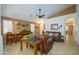 Bright and airy living room with comfortable leather furniture, tile flooring, and a versatile layout at 17710 W Buena Vista Dr, Surprise, AZ 85374