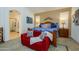 The main bedroom has neutral walls, a loveseat, and decor at 17710 W Buena Vista Dr, Surprise, AZ 85374