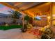 Covered patio with cozy seating, string lights, ceiling fan, and a view of the backyard and pool at 17710 W Buena Vista Dr, Surprise, AZ 85374