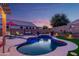 Backyard pool featuring elegant lighting, a seating swing, lush plants and tasteful decor at 17710 W Buena Vista Dr, Surprise, AZ 85374