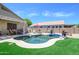 Backyard features a refreshing pool, comfortable seating area, and well-manicured landscaping at 17710 W Buena Vista Dr, Surprise, AZ 85374