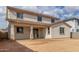 Back exterior of home shows covered patio, backyard space, neutral stucco, and clay tile roof at 18383 W Monte Lindo Ln, Surprise, AZ 85387