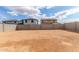 Expansive backyard, enclosed by a tall block fence, offering privacy and space for customization and outdoor activities at 18383 W Monte Lindo Ln, Surprise, AZ 85387