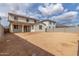 Back exterior of home shows covered patio, backyard space, neutral stucco, and clay tile roof at 18383 W Monte Lindo Ln, Surprise, AZ 85387