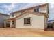 Back exterior of home shows covered patio, backyard space, neutral stucco, and clay tile roof at 18383 W Monte Lindo Ln, Surprise, AZ 85387