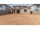 Back exterior of home shows covered patio, backyard space, neutral stucco, and clay tile roof at 18383 W Monte Lindo Ln, Surprise, AZ 85387