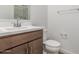 Bathroom features stylish vanity with sink, toilet, and a towel rack at 18383 W Monte Lindo Ln, Surprise, AZ 85387