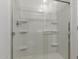 Bathroom includes a shower with a clear glass door and built in shelves at 18383 W Monte Lindo Ln, Surprise, AZ 85387
