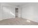 Clean bedroom featuring carpeted floor, white walls, and a large closet at 18383 W Monte Lindo Ln, Surprise, AZ 85387