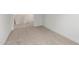 A carpeted room with white walls and trim, perfect for use as a bedroom or storage at 18383 W Monte Lindo Ln, Surprise, AZ 85387