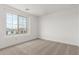 Bright bedroom featuring carpeted floor, white walls, and a large window offering a pleasant view at 18383 W Monte Lindo Ln, Surprise, AZ 85387