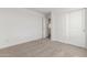 Clean bedroom featuring carpeted floor, white walls, and a large closet at 18383 W Monte Lindo Ln, Surprise, AZ 85387