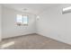 Bright bedroom featuring carpeted floor, white walls, and two windows with a view at 18383 W Monte Lindo Ln, Surprise, AZ 85387