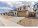 Welcoming two-story home showcasing desert landscaping, a two-car garage, and a charming front facade with shuttered windows at 18383 W Monte Lindo Ln, Surprise, AZ 85387