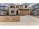 Charming two-story home with desert landscaping, a two-car garage, and a welcoming front facade at 18383 W Monte Lindo Ln, Surprise, AZ 85387