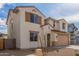 Welcoming two-story home showcasing desert landscaping, a two-car garage, and a charming front facade with shuttered windows at 18383 W Monte Lindo Ln, Surprise, AZ 85387