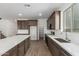 Open kitchen with stainless appliances, gray cabinets, white backsplash, and an island with white countertops at 18383 W Monte Lindo Ln, Surprise, AZ 85387