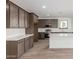 The kitchen features modern cabinets, stainless steel appliances, and hard wood flooring at 18383 W Monte Lindo Ln, Surprise, AZ 85387