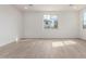 The living room features neutral walls, natural lighting, and hard wood flooring at 18383 W Monte Lindo Ln, Surprise, AZ 85387