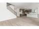 This open-concept home features a modern staircase, hard wood flooring, and ample light at 18383 W Monte Lindo Ln, Surprise, AZ 85387