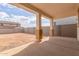 Covered patio with concrete flooring offers shade and a view of the home's backyard at 18383 W Monte Lindo Ln, Surprise, AZ 85387