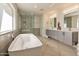 Modern bathroom with a freestanding tub, glass shower, and dual vanity sinks at 1911 E Claremont St, Phoenix, AZ 85016