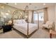 Beautiful bedroom featuring a canopy bed, designer wallpaper, and modern lighting fixtures at 1911 E Claremont St, Phoenix, AZ 85016