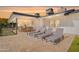 Covered patio with lounge chairs, a dining table, and an outdoor dining setting at 1911 E Claremont St, Phoenix, AZ 85016
