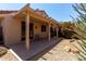 Covered back patio with desert landscaping and seating at 19963 N Window Rock Dr, Surprise, AZ 85374
