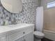 Bathroom featuring modern mosaic tile and a vanity with a white countertop at 19963 N Window Rock Dr, Surprise, AZ 85374