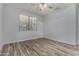 Bedroom featuring wood-look tile flooring, neutral paint, and bright window at 19963 N Window Rock Dr, Surprise, AZ 85374