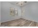 Bright bedroom with windows that let in natural light and wood-look flooring at 19963 N Window Rock Dr, Surprise, AZ 85374