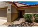Charming home with a walkway to the front door, featuring desert landscaping and a two-car garage at 19963 N Window Rock Dr, Surprise, AZ 85374