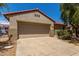 Charming home with a two-car garage, desert landscaping, and a beautiful mature shade tree at 19963 N Window Rock Dr, Surprise, AZ 85374