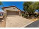 Charming home with a two-car garage, desert landscaping, and a beautiful mature shade tree at 19963 N Window Rock Dr, Surprise, AZ 85374