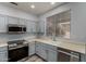 Bright kitchen with stainless steel appliances and ample cabinet space at 19963 N Window Rock Dr, Surprise, AZ 85374