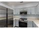 Kitchen features stainless appliances, light countertops, and updated cabinets at 19963 N Window Rock Dr, Surprise, AZ 85374