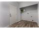 Functional laundry room with modern wood-look flooring and storage space at 19963 N Window Rock Dr, Surprise, AZ 85374