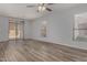 Bright living room with wood-look tile flooring and sliding glass doors at 19963 N Window Rock Dr, Surprise, AZ 85374